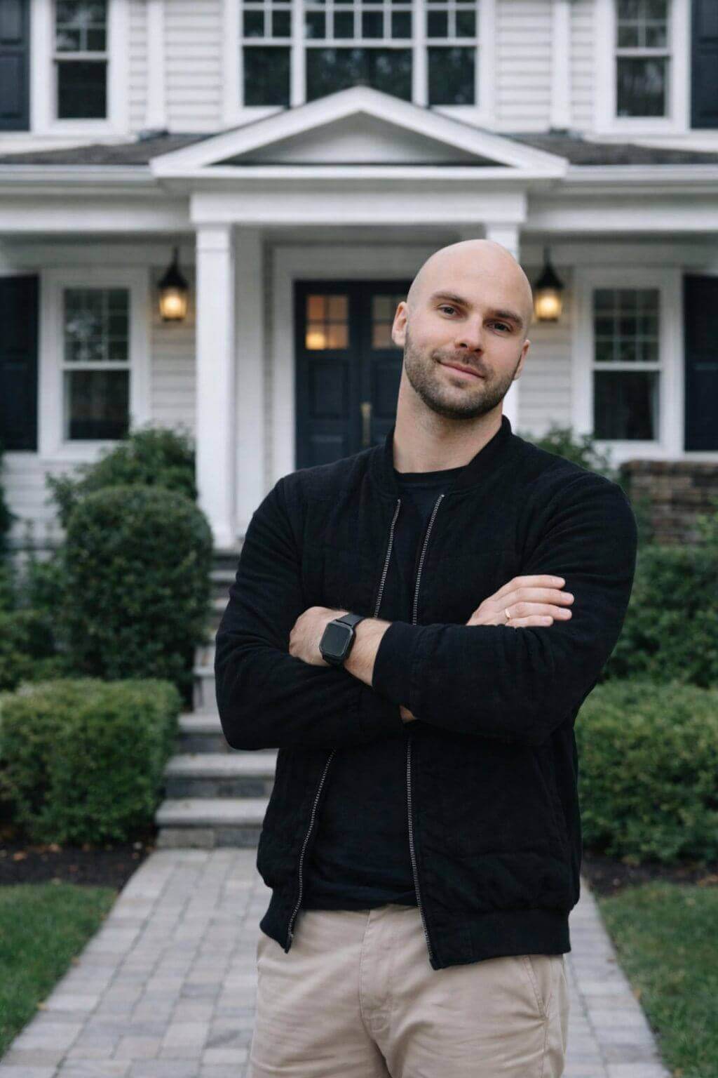 Denys, founder of Will-Stone Inc., in front of a finished home